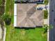 Birds-eye view of a single-Gathering home featuring a large backyard, well-manicured lawn, and nearby pond at 6606 Pullen Ct, Tampa, FL 33625