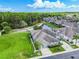 A high angle shot of a house surrounded by green lawn and neighboring houses with a pond behind the house at 6606 Pullen Ct, Tampa, FL 33625