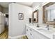 Spacious bathroom features double sinks, white cabinets, wood floors, and rustic mirror frames at 6606 Pullen Ct, Tampa, FL 33625
