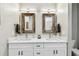 Bright bathroom with double sinks, quartz countertops, and rustic wood-framed mirrors at 6606 Pullen Ct, Tampa, FL 33625