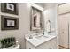 Charming bathroom features a rustic framed mirror and a bright white vanity and top at 6606 Pullen Ct, Tampa, FL 33625