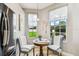 Charming breakfast nook filled with natural light and cozy seating by the window and stainless steel refrigerator at 6606 Pullen Ct, Tampa, FL 33625