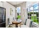 Bright breakfast nook with a round table, comfortable seating, and large windows offering backyard views at 6606 Pullen Ct, Tampa, FL 33625