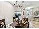Bright dining area with natural light, wood chairs, glass table, and view of the foyer and kitchen at 6606 Pullen Ct, Tampa, FL 33625