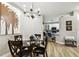 Elegant dining room with a glass table, comfortable seating, and a view of the modern kitchen at 6606 Pullen Ct, Tampa, FL 33625