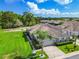 Aerial view of home featuring a large lawn, mature landscaping, and paved driveway at 6606 Pullen Ct, Tampa, FL 33625