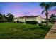 Sprawling single story home with well-maintained lawn and garden, side view from street at 6606 Pullen Ct, Tampa, FL 33625