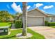 Charming one-story home with a two-car garage, well-manicured lawn, and lush landscaping at 6606 Pullen Ct, Tampa, FL 33625