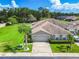 Aerial view of a home with a big lawn, mature landscaping, and two-car garage at 6606 Pullen Ct, Tampa, FL 33625