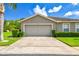 Charming one-story home with a two-car garage, well-manicured lawn, and lush landscaping at 6606 Pullen Ct, Tampa, FL 33625
