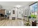Welcoming foyer features wood-look tile flooring, neutral walls, large window, and decorative mirror and furniture at 6606 Pullen Ct, Tampa, FL 33625
