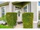 Inviting home exterior featuring a decorated door, lush bushes, and welcoming front entrance at 6606 Pullen Ct, Tampa, FL 33625
