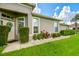 Inviting home exterior featuring a lovely garden, lush bushes, and welcoming front entrance at 6606 Pullen Ct, Tampa, FL 33625