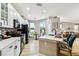 Bright kitchen featuring stainless appliances, white cabinetry, an island with seating, and a connected dining area at 6606 Pullen Ct, Tampa, FL 33625