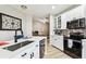 Bright kitchen features stainless steel appliances, white cabinets, and mosaic backsplash at 6606 Pullen Ct, Tampa, FL 33625