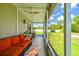 Relax in the screened lanai featuring comfortable seating and views of the lush green lawn at 6606 Pullen Ct, Tampa, FL 33625