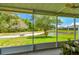 The screened lanai offers picturesque views of a tranquil pond and lush green backyard at 6606 Pullen Ct, Tampa, FL 33625