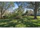 A serene community picnic area with picnic tables shaded by mature trees at 6606 Pullen Ct, Tampa, FL 33625