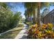 Scenic walkway leading to the community pool with lush landscaping, palm trees, and a relaxing atmosphere at 6606 Pullen Ct, Tampa, FL 33625
