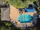 Overhead shot of a community pool with lounge chairs, tables, umbrellas, and pool house at 6606 Pullen Ct, Tampa, FL 33625