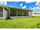This screened patio features a comfortable seating area and sliding door access to a spacious, well-maintained backyard at 6606 Pullen Ct, Tampa, FL 33625