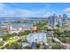 Expansive aerial view of the condo building and surrounding cityscape with water views and beautiful parks nearby at 700 Beach Ne Dr # 602, St Petersburg, FL 33701