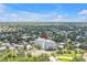 Panoramic aerial view showcasing the condo building in its residential neighborhood, lush landscape, and street access at 700 Beach Ne Dr # 602, St Petersburg, FL 33701
