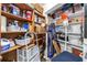 Organized basement storage area with wooden and white shelving, filled with boxes and household items at 700 Beach Ne Dr # 602, St Petersburg, FL 33701