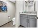 Powder room featuring gray vanity with granite countertop, and modern fixtures at 700 Beach Ne Dr # 602, St Petersburg, FL 33701