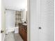Well-lit bathroom featuring tiled floors, vanity with dark wood cabinets, and a shower-tub combo at 700 Beach Ne Dr # 602, St Petersburg, FL 33701
