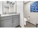 The bathroom features a gray vanity with granite countertop next to a toilet and an artwork on the wall at 700 Beach Ne Dr # 602, St Petersburg, FL 33701