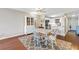 Bright dining area with hardwood floors, a white table and chairs, and view into the adjacent modern kitchen at 700 Beach Ne Dr # 602, St Petersburg, FL 33701