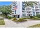 The Harbour Hill building's exterior featuring lush landscaping and a clear building entrance at 700 Beach Ne Dr # 602, St Petersburg, FL 33701