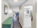 Hallway featuring hardwood floors, view of dining area, and a glimpse of living room at 700 Beach Ne Dr # 602, St Petersburg, FL 33701