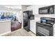 Well-lit kitchen features black appliances and white cabinets, creating a clean and efficient cooking area at 700 Beach Ne Dr # 602, St Petersburg, FL 33701