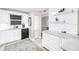 Bright kitchen boasts white cabinetry, a black dishwasher and a view through the doorway to the next room at 700 Beach Ne Dr # 602, St Petersburg, FL 33701
