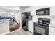 Well-lit kitchen features black appliances and white cabinets, creating a clean and efficient cooking area at 700 Beach Ne Dr # 602, St Petersburg, FL 33701