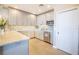 Contemporary kitchen boasts gray cabinetry, sleek appliances, granite counters, and tile flooring at 700 Beach Ne Dr # 602, St Petersburg, FL 33701