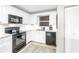 Bright kitchen with white cabinetry, marble countertops, and black appliances, providing a modern and sleek design at 700 Beach Ne Dr # 602, St Petersburg, FL 33701