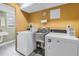 Laundry room with white appliances, a stainless steel sink, and a window offering natural light at 700 Beach Ne Dr # 602, St Petersburg, FL 33701