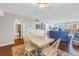 A bright dining room with white table and chairs leads to a spacious living room with a view at 700 Beach Ne Dr # 602, St Petersburg, FL 33701