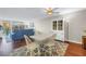 Bright living room featuring a white china cabinet and light-colored dining table, offering a comfortable space at 700 Beach Ne Dr # 602, St Petersburg, FL 33701