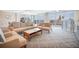 Inviting living room with plush seating, glass coffee table, and sliding doors to a balcony with scenic views at 700 Beach Ne Dr # 602, St Petersburg, FL 33701
