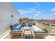 Cozy rooftop seating area with plush blue cushions and stunning city skyline backdrop at 700 Beach Ne Dr # 602, St Petersburg, FL 33701