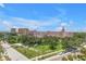 Charming street view showcases lush greenery, tropical palms and views of the Don CeSar Hotel at 700 Beach Ne Dr # 602, St Petersburg, FL 33701