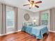 Comfortable bedroom showcasing hardwood floors, a ceiling fan, and natural lighting at 708 E Patterson St, Tampa, FL 33604