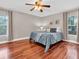 Cozy bedroom featuring hardwood floors, neutral walls, and soft, natural light from the windows at 708 E Patterson St, Tampa, FL 33604