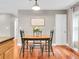 Dining area with wood table and chairs next to kitchen with wood flooring at 708 E Patterson St, Tampa, FL 33604