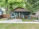 Charming bungalow with blue siding, inviting front porch, and lush landscaping at 708 E Patterson St, Tampa, FL 33604