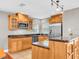 Well-equipped kitchen with wood cabinets, granite countertops, and stainless steel appliances at 708 E Patterson St, Tampa, FL 33604